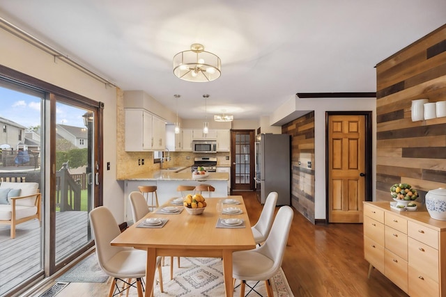 dining area with a chandelier and dark wood-type flooring