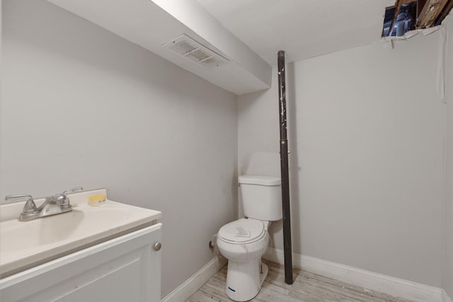 7521 S Parnell Ave, Chicago, IL 60620 - half bathroom with toilet, baseboards, visible vents, wood finished floors, and vanity