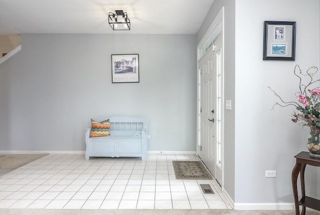 foyer entrance featuring visible vents, baseboards, and light tile patterned floors