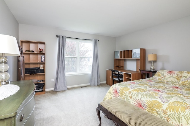 bedroom with baseboards, light colored carpet, and visible vents