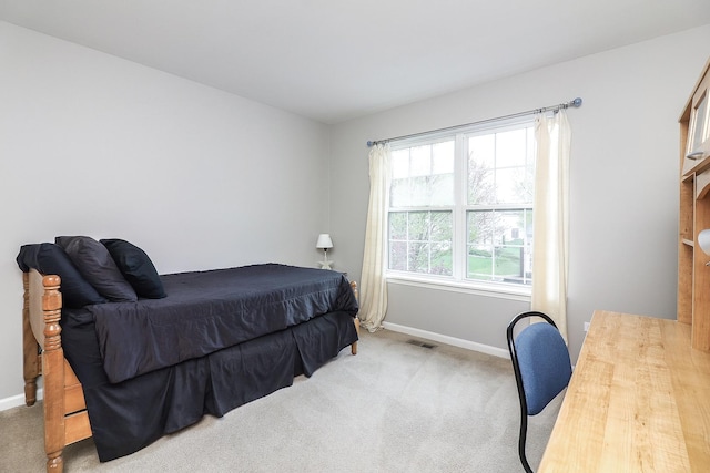 carpeted bedroom with baseboards and visible vents