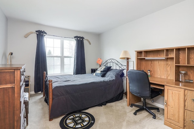 bedroom with baseboards and light carpet