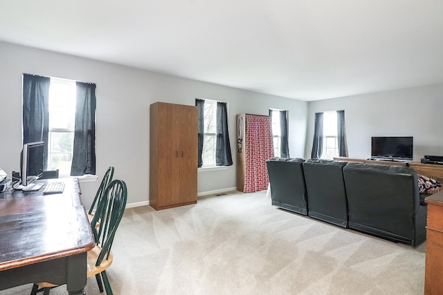 interior space with baseboards and light carpet