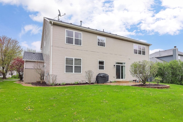 rear view of house with a lawn and a patio
