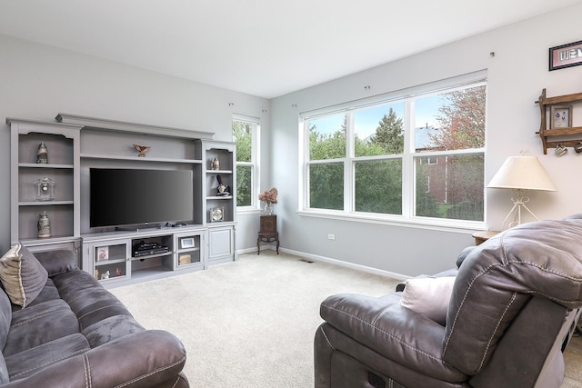 living area with baseboards and light carpet