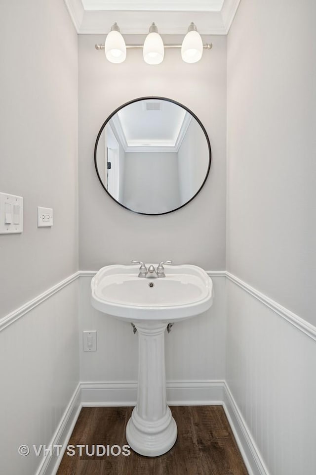 bathroom with baseboards and wood finished floors