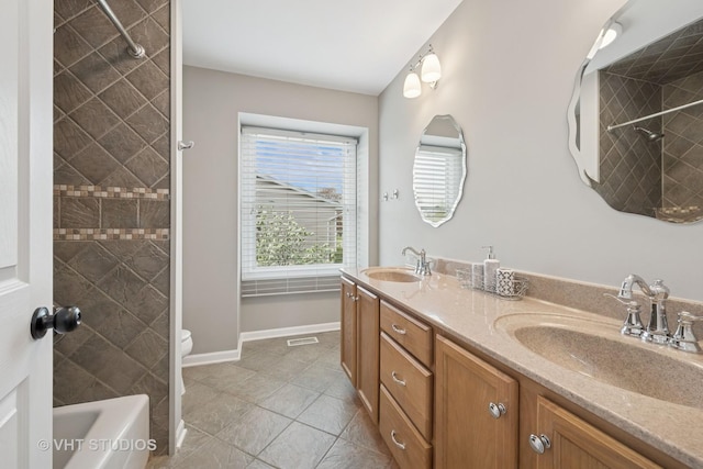 full bathroom with double vanity, a sink, tile patterned floors, and visible vents