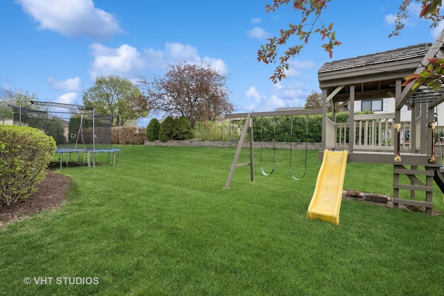 view of jungle gym featuring a lawn and a trampoline