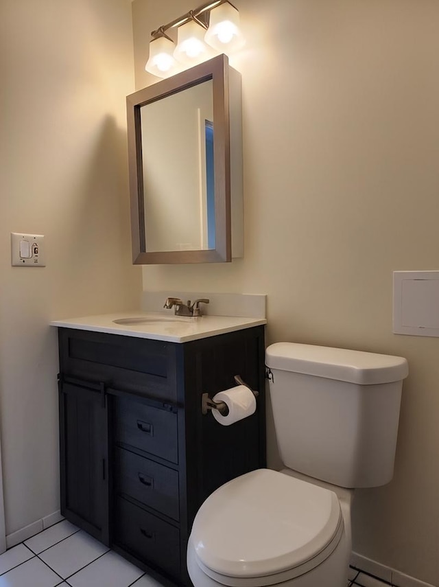 bathroom with vanity, tile patterned flooring, toilet, and baseboards