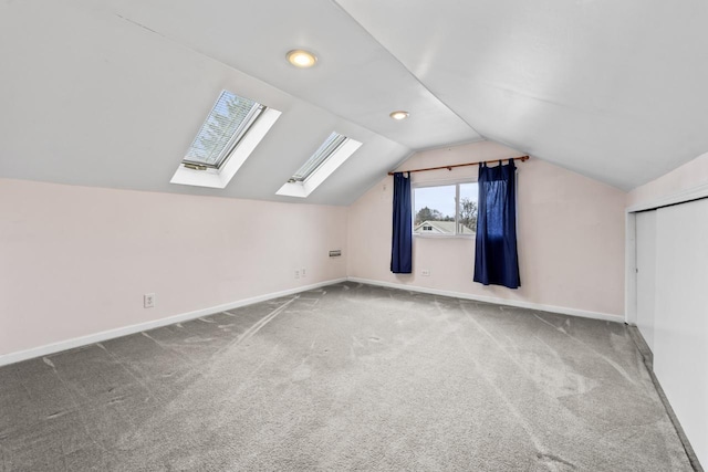 additional living space featuring recessed lighting, carpet flooring, baseboards, and lofted ceiling with skylight
