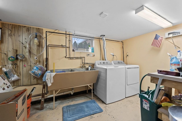 laundry room featuring washer and dryer, laundry area, and a sink