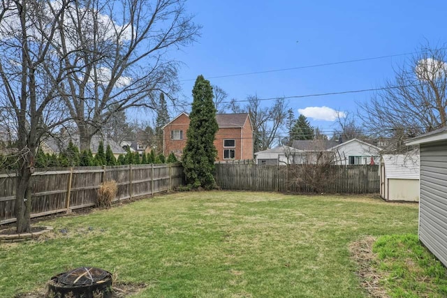 view of yard with an outdoor fire pit and a fenced backyard