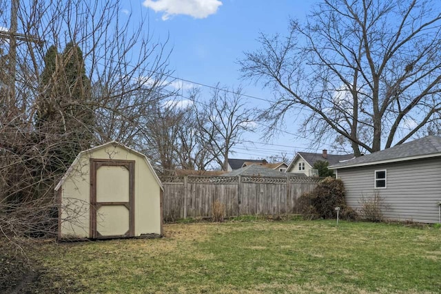 view of yard with an outbuilding, a shed, and fence