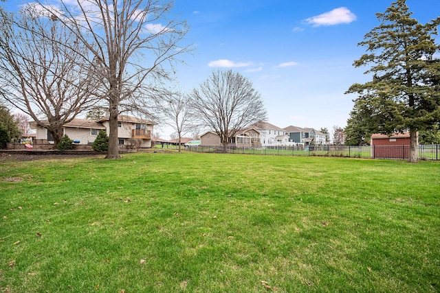 view of yard featuring fence and a residential view
