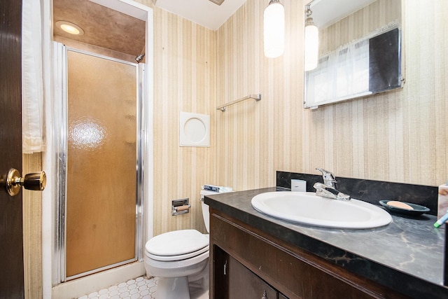 full bathroom featuring tile patterned floors, toilet, wallpapered walls, a shower stall, and vanity