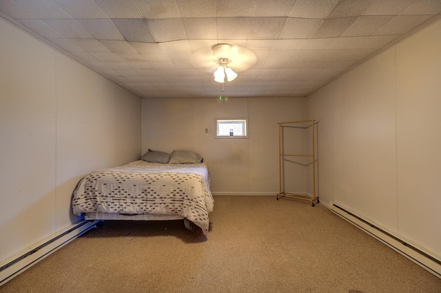 bedroom featuring a baseboard heating unit and carpet floors