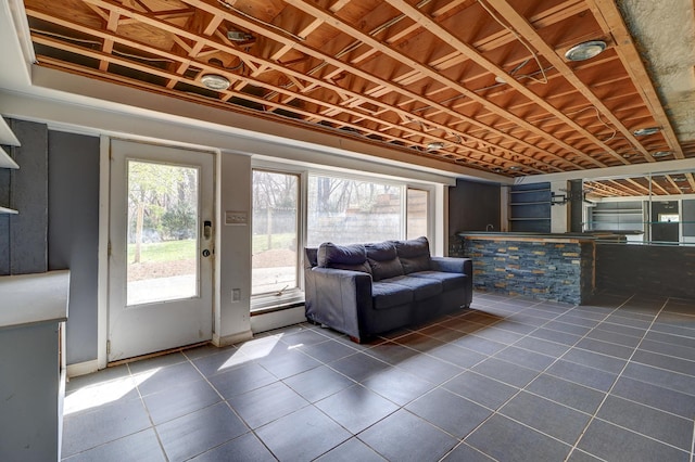 interior space featuring a healthy amount of sunlight and dark tile patterned flooring