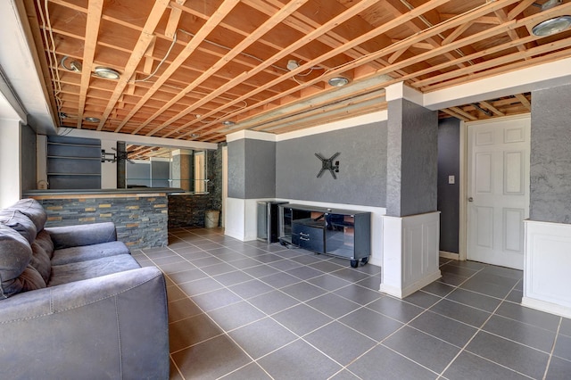 unfurnished living room featuring dark tile patterned flooring