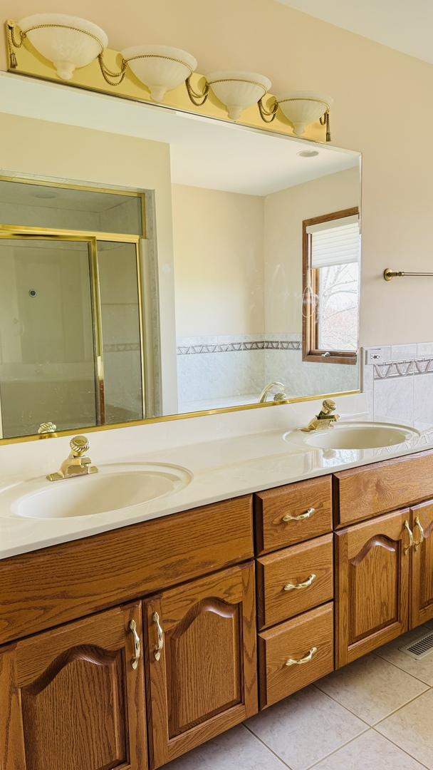 10901 Fawn Trail Dr, Orland Park, IL 60467 - bathroom with tile patterned floors, a sink, and a stall shower