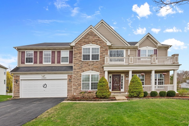1289 Mallard Ln, Hoffman Estates, IL 60192 - view of front of home featuring a front lawn, a balcony, an attached garage, driveway, and covered porch