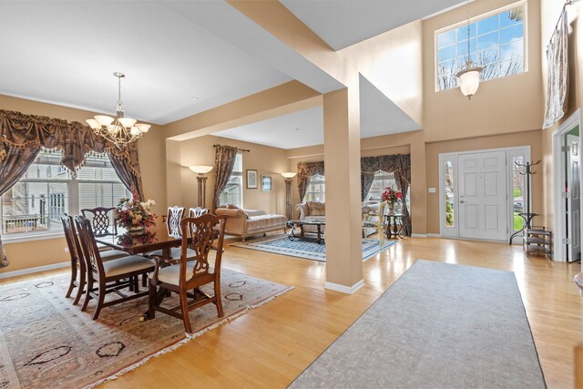1289 Mallard Ln, Hoffman Estates, IL 60192 - dining area with a chandelier, a wealth of natural light, light wood finished floors, and baseboards