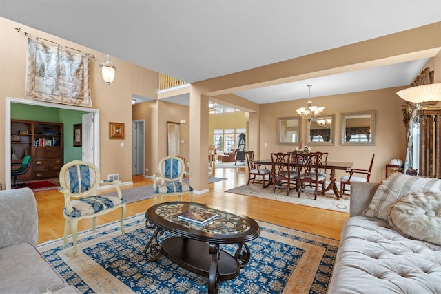 1289 Mallard Ln, Hoffman Estates, IL 60192 - living room with an inviting chandelier, wood finished floors, and baseboards