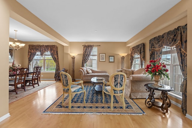 1289 Mallard Ln, Hoffman Estates, IL 60192 - living room with wood finished floors, baseboards, and an inviting chandelier