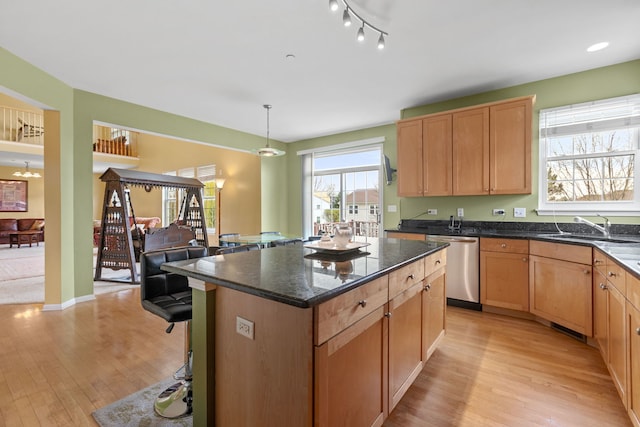 1289 Mallard Ln, Hoffman Estates, IL 60192 - kitchen featuring dishwasher, a center island, a sink, and light wood-style flooring