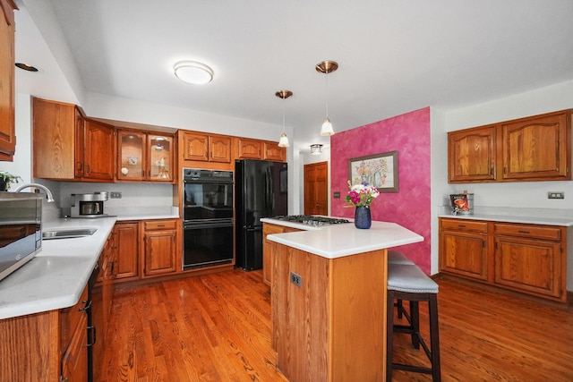2756 Fox River Ln, Naperville, IL 60565 - kitchen with black appliances, brown cabinetry, a sink, and wood finished floors