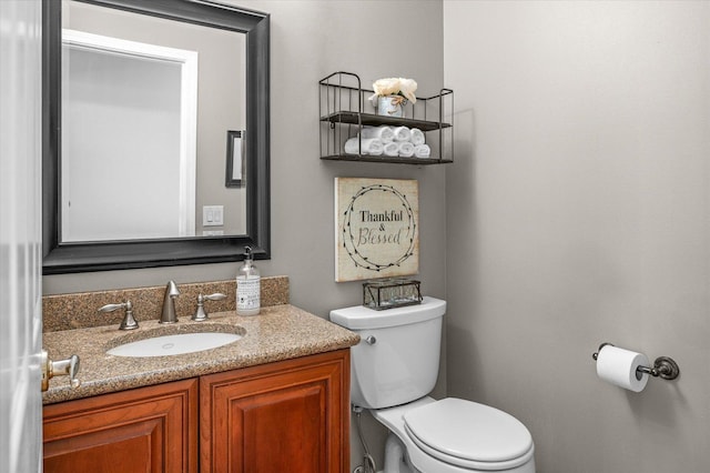 half bath featuring toilet and vanity