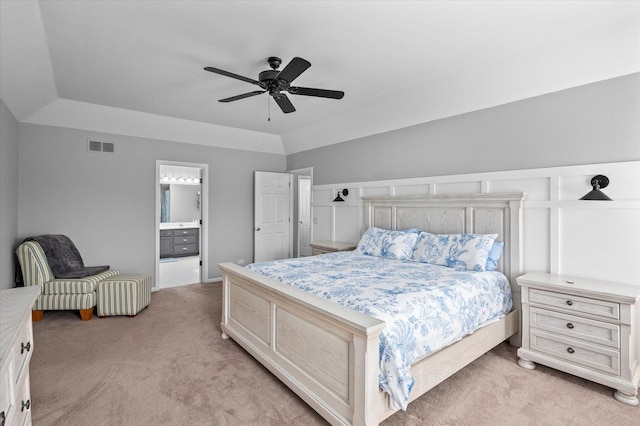 bedroom featuring visible vents, a ceiling fan, ensuite bath, and light carpet