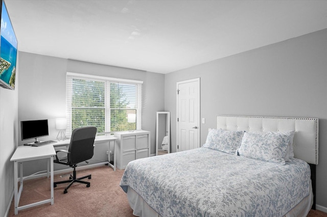 carpeted bedroom featuring baseboards