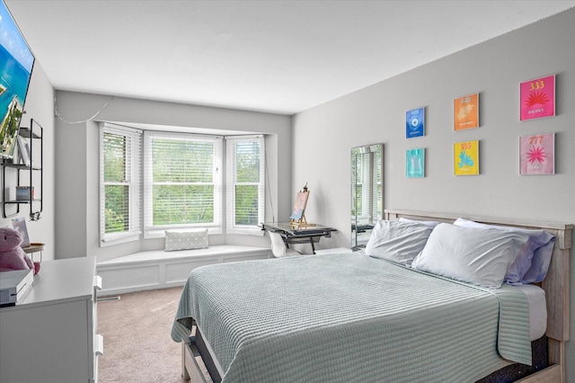 bedroom featuring light carpet