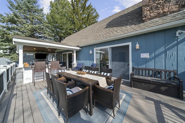 wooden terrace featuring outdoor dining area