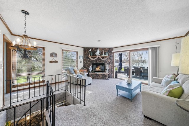 carpeted living room with a fireplace, a textured ceiling, crown molding, and an inviting chandelier