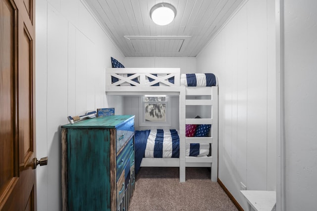 bedroom with attic access and carpet