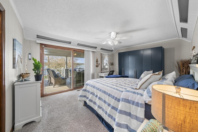 carpeted bedroom featuring access to outside, a textured ceiling, and crown molding
