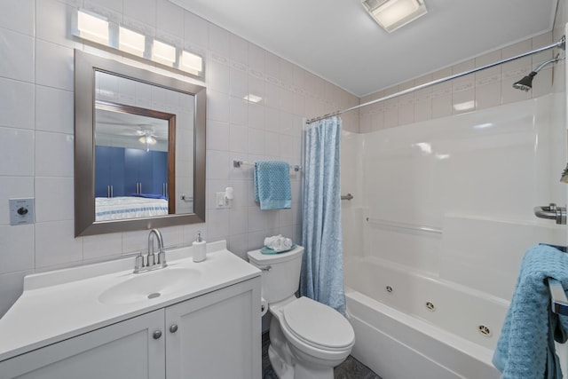 full bathroom featuring vanity, toilet, tile walls, decorative backsplash, and a combined bath / shower with jetted tub
