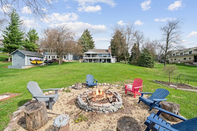 view of yard with a fire pit and an outbuilding