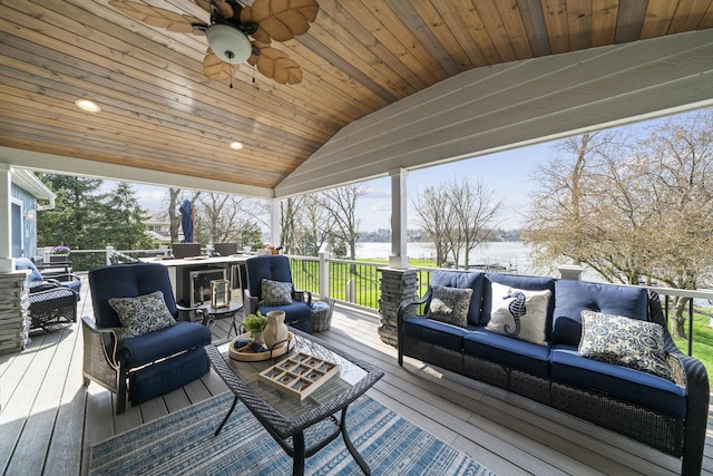 sunroom with vaulted ceiling, a ceiling fan, wooden ceiling, and an outdoor hangout area