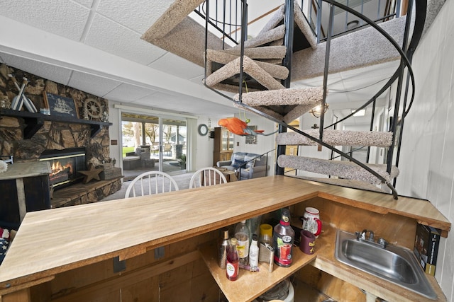interior space with a stone fireplace and stairs