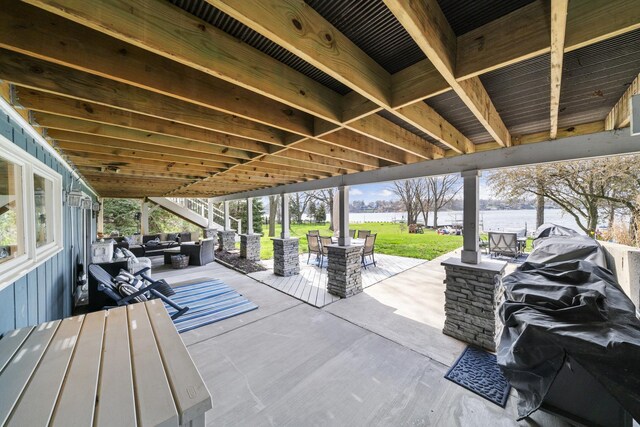 view of patio / terrace featuring an outdoor living space, outdoor dining space, and a water view
