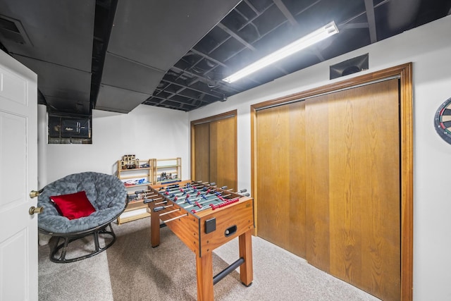 recreation room with visible vents and carpet