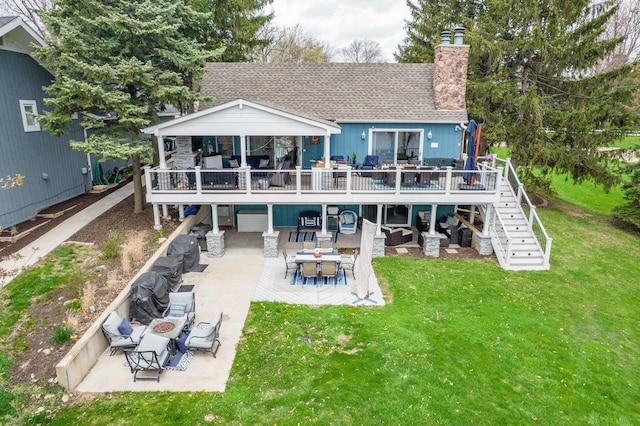 back of house with a lawn, stairway, a chimney, and a patio