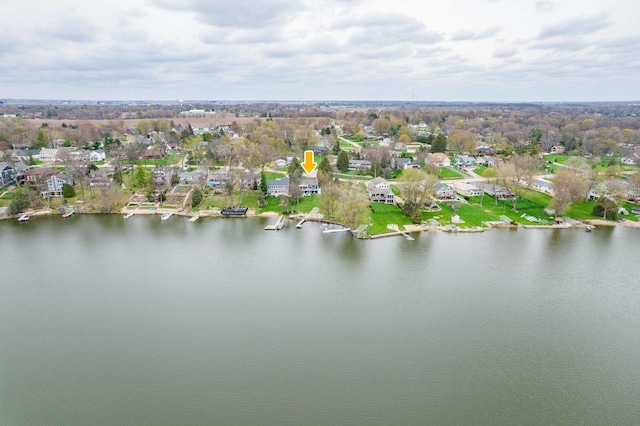 drone / aerial view featuring a residential view and a water view