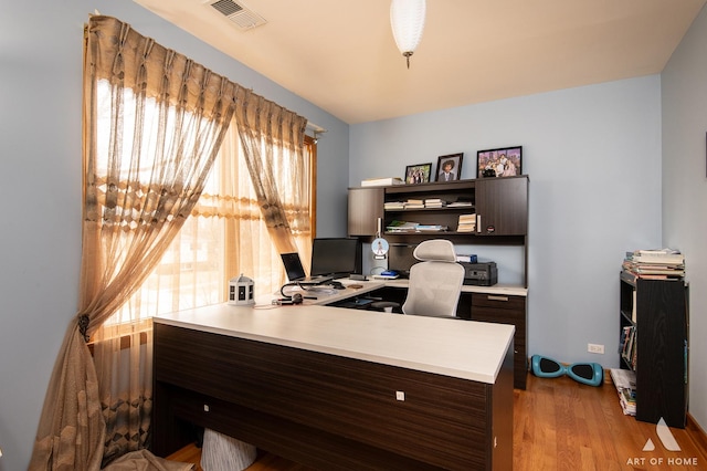 office with wood finished floors and visible vents