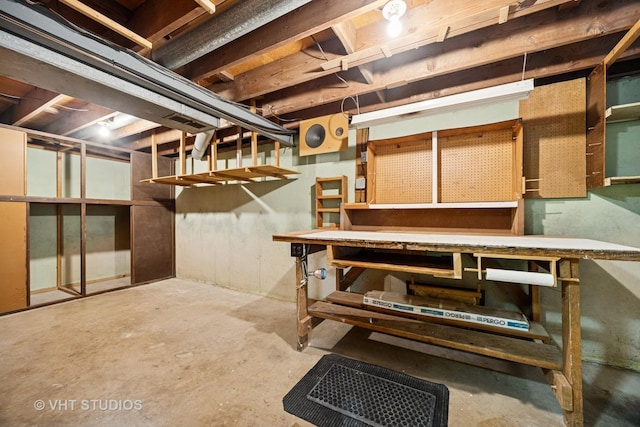 unfinished basement featuring a workshop area
