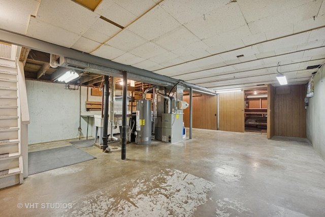 unfinished basement featuring water heater and heating unit