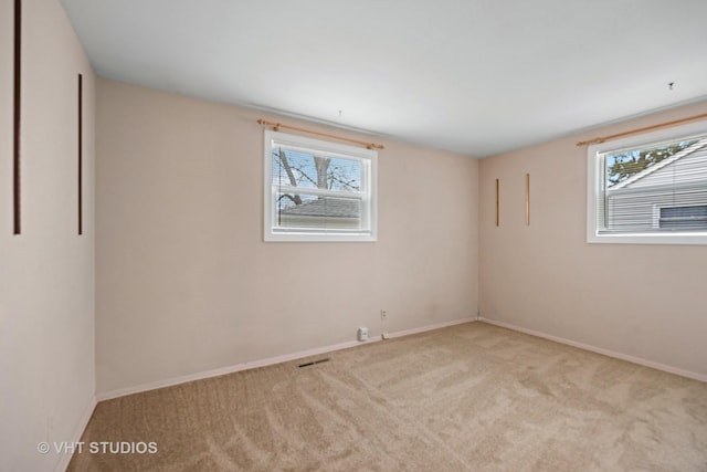 spare room with carpet floors and baseboards
