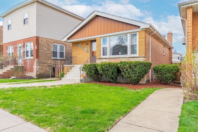 5626 S Nashville Ave, Chicago, IL 60638 - bungalow-style house featuring a front yard, brick siding, and board and batten siding